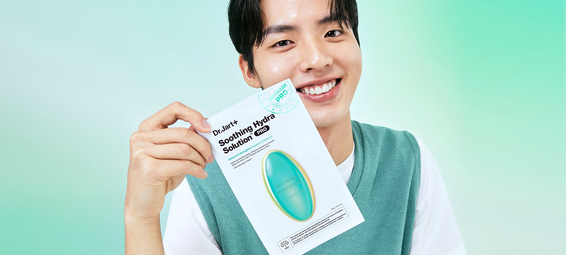 Man with glowing moisturized skin holds Dr.Jart+'s moisturizing face mask